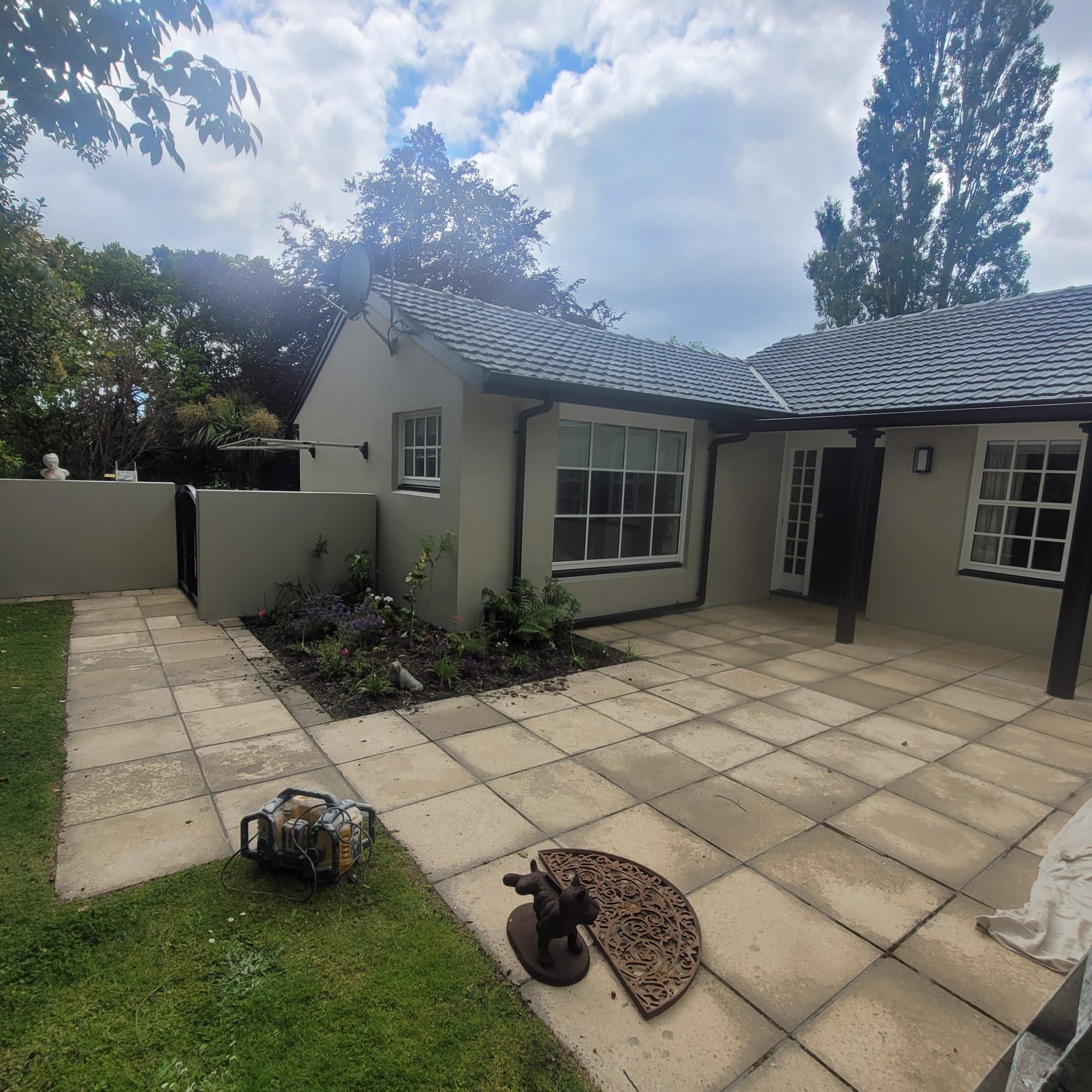 Exterior repaint on a cream home with a tile roof