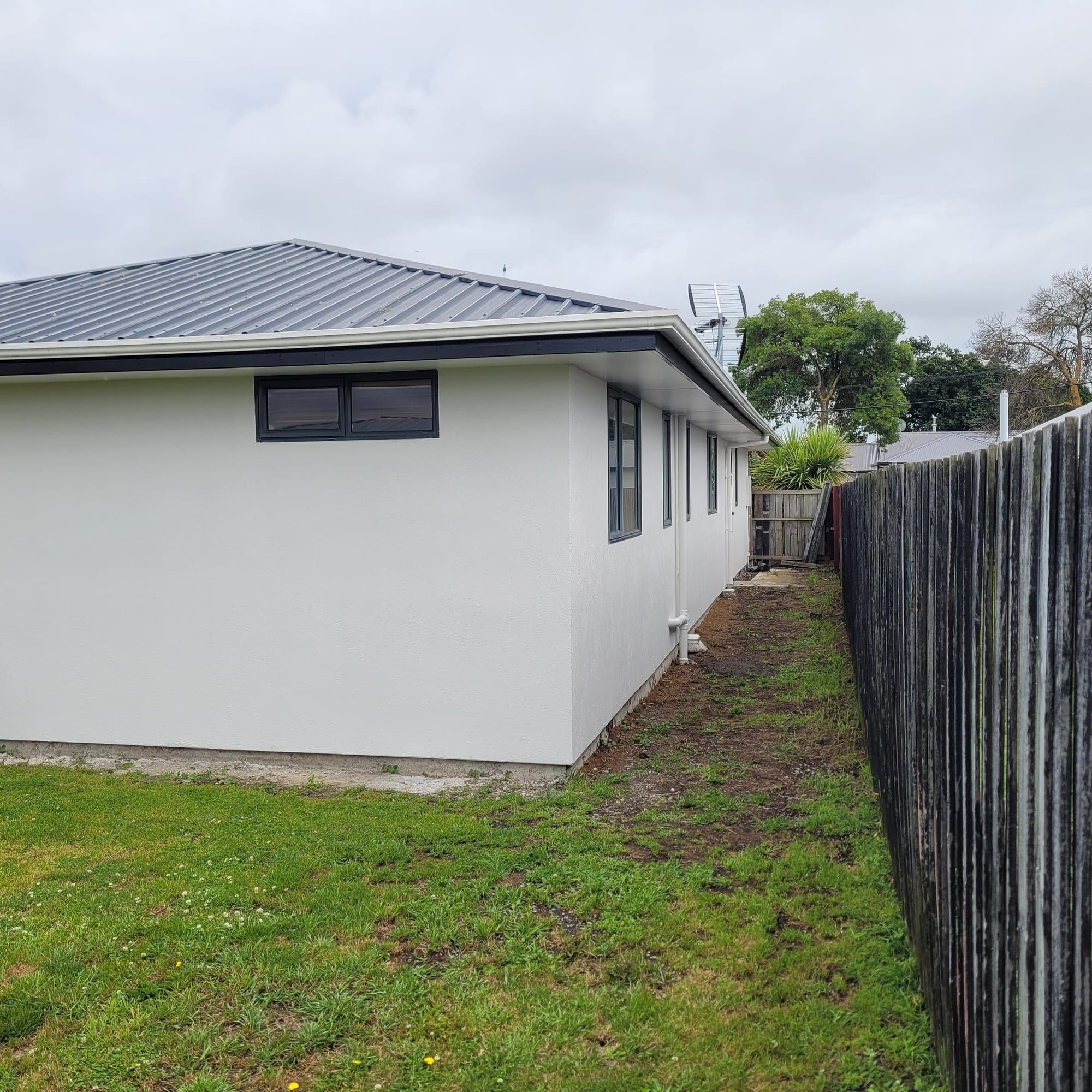 Bungalow with a restored dark tile roof