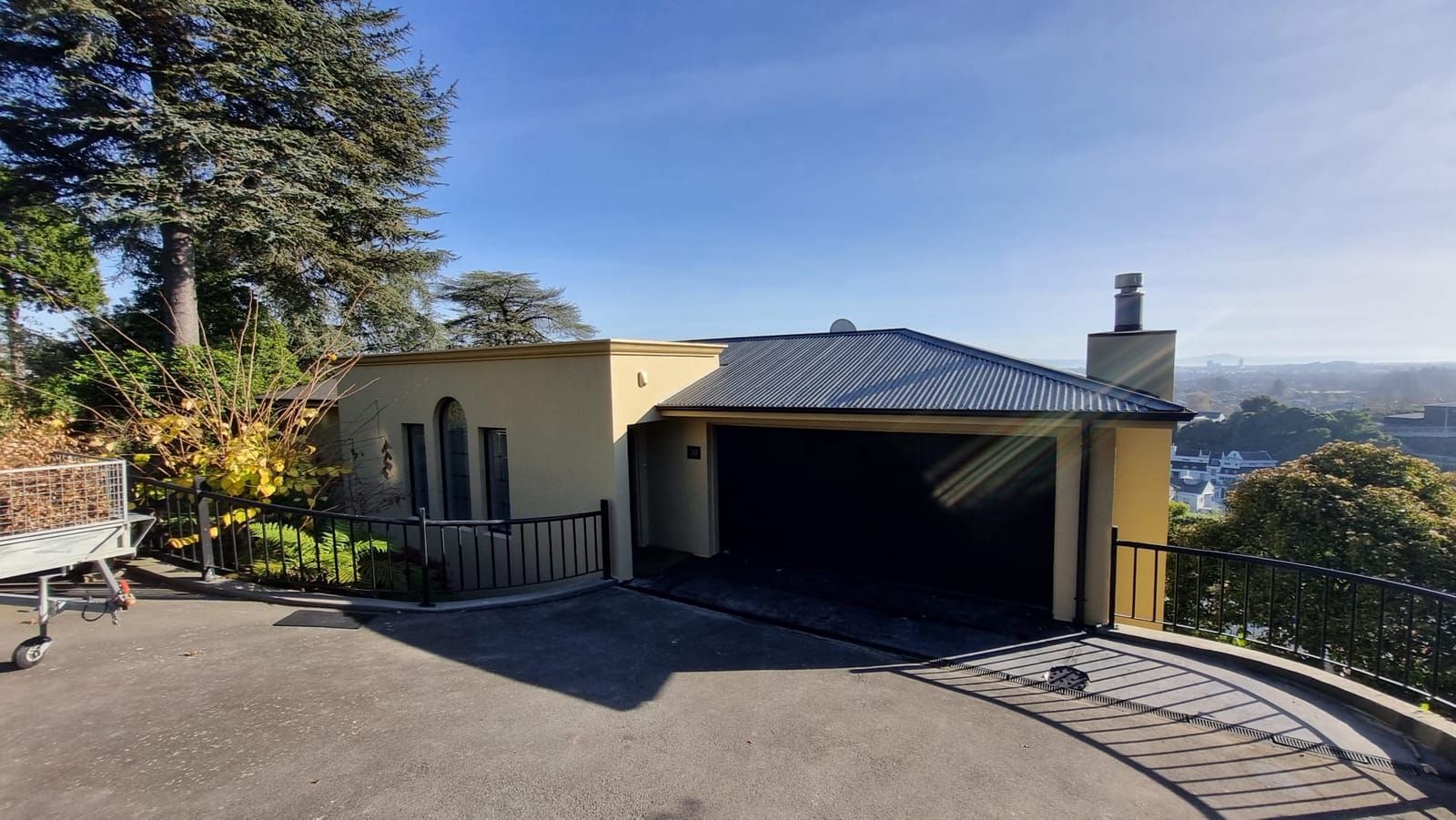 Hillside home with repainted walls and a recoated dark roof