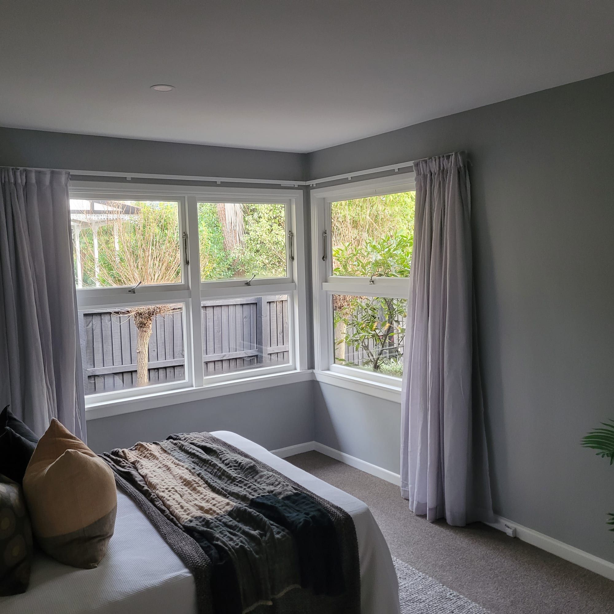 Lounge repaint with a bay window and garden view