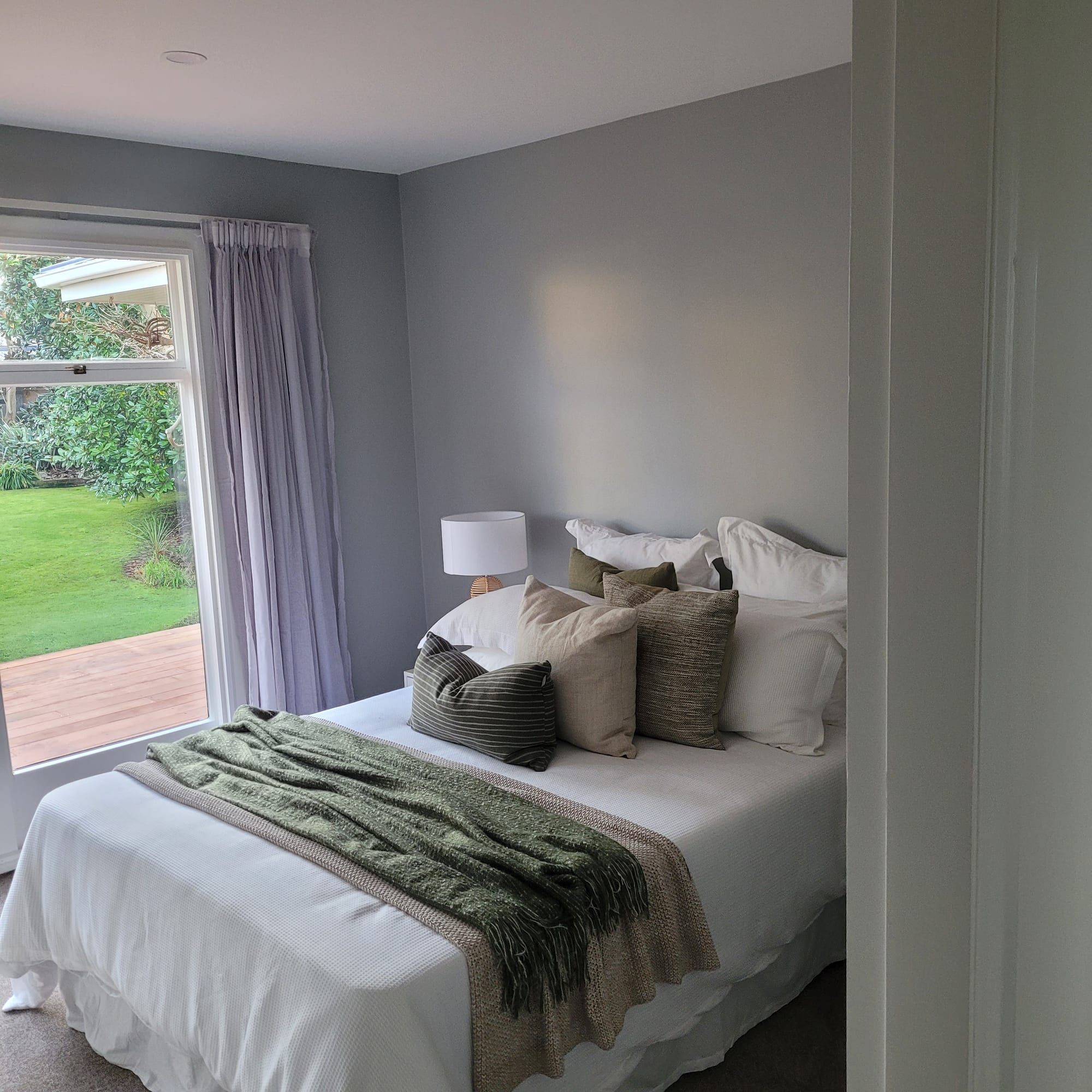 Clean repainted bedroom styled in soft neutrals