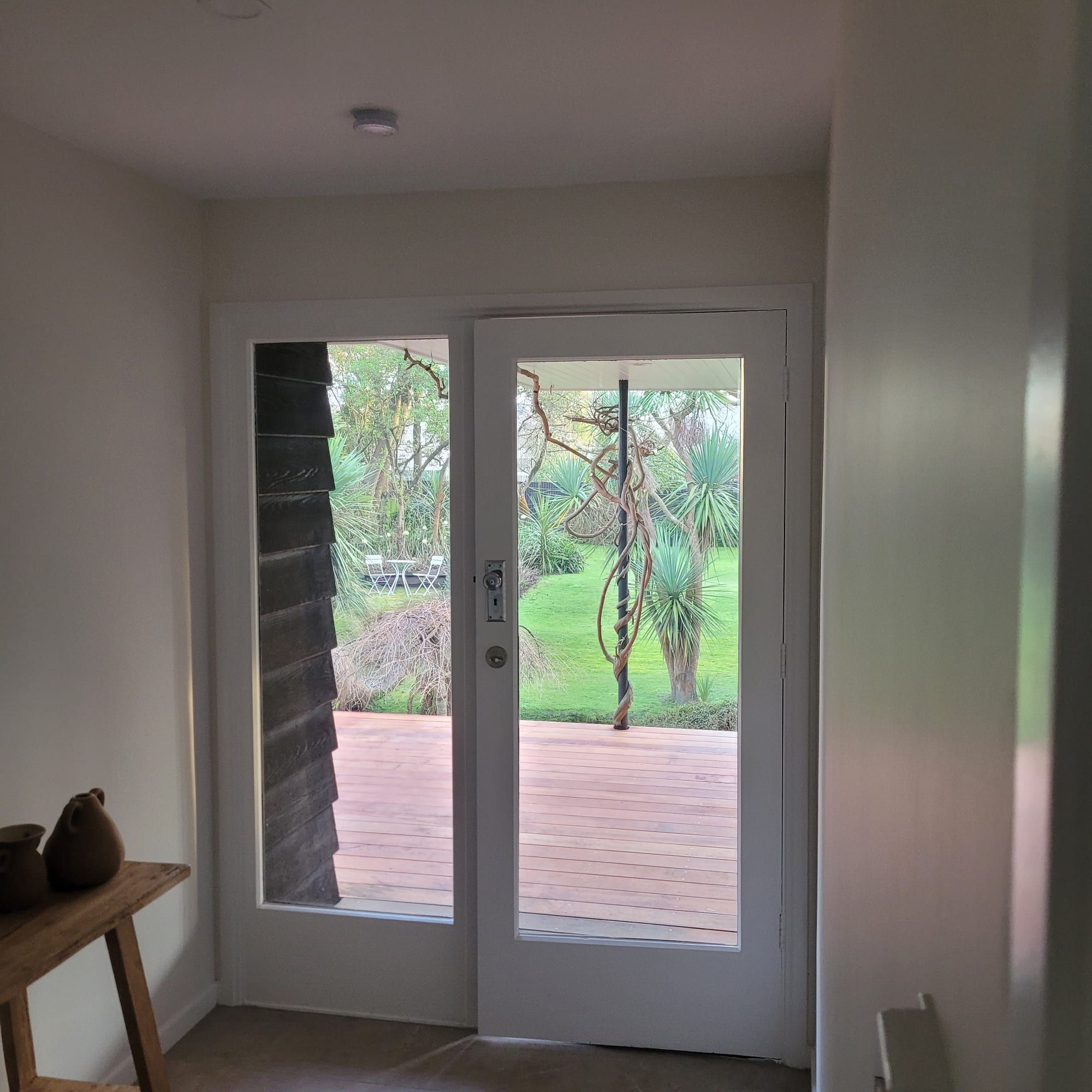 Living area repaint opening to a deck through french doors