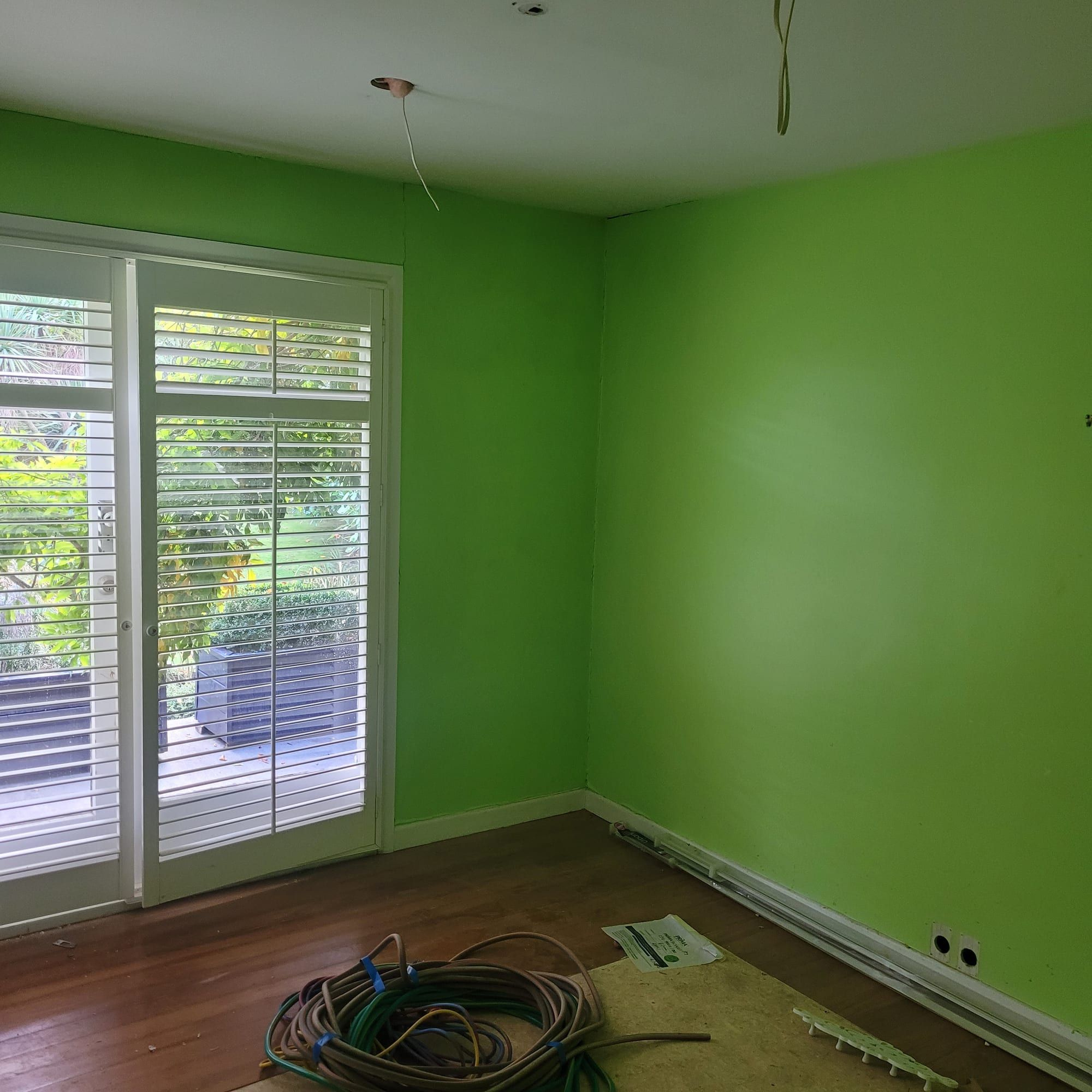 Fresh bold-green feature wall against a crisp white room