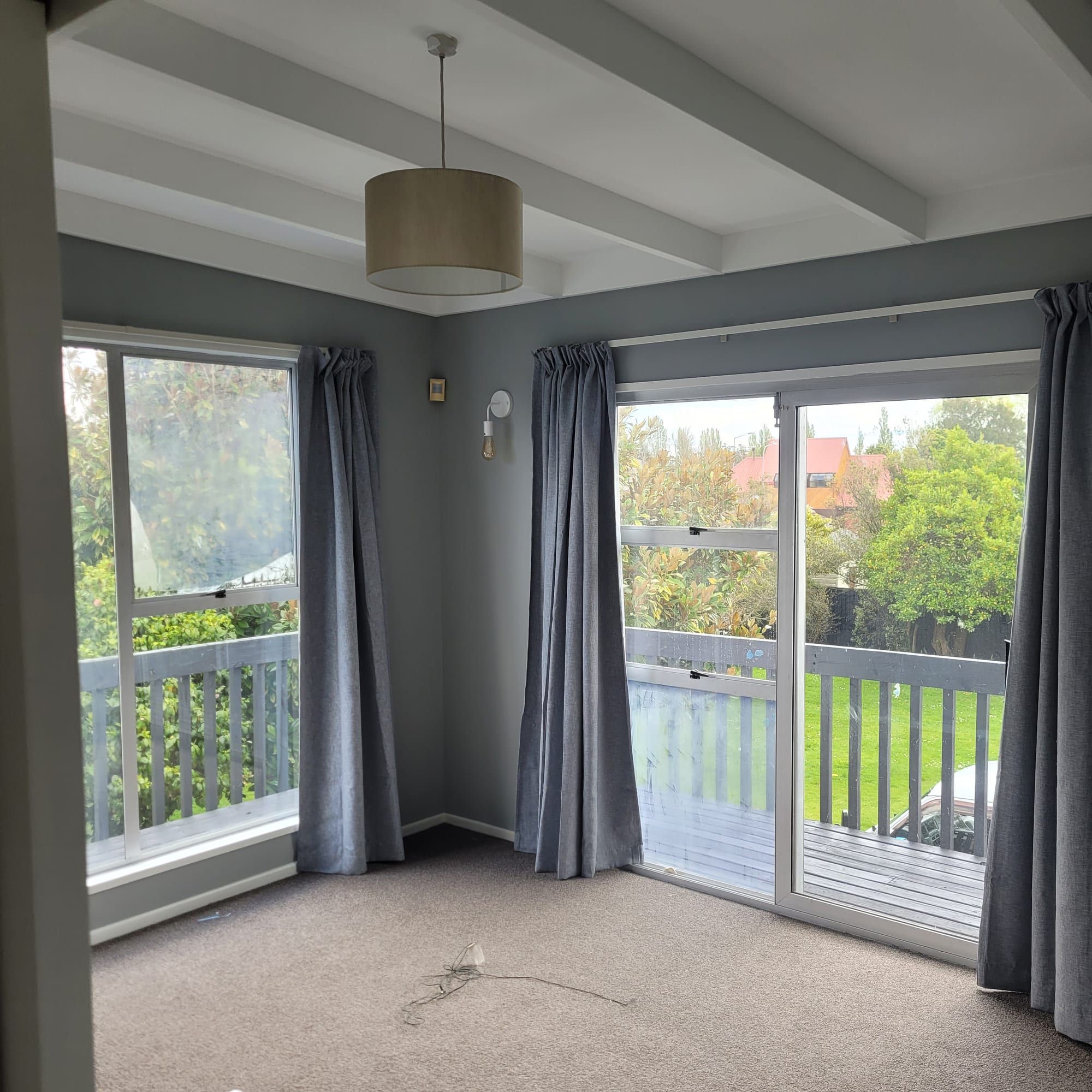 Repainted lounge with a large window and garden view