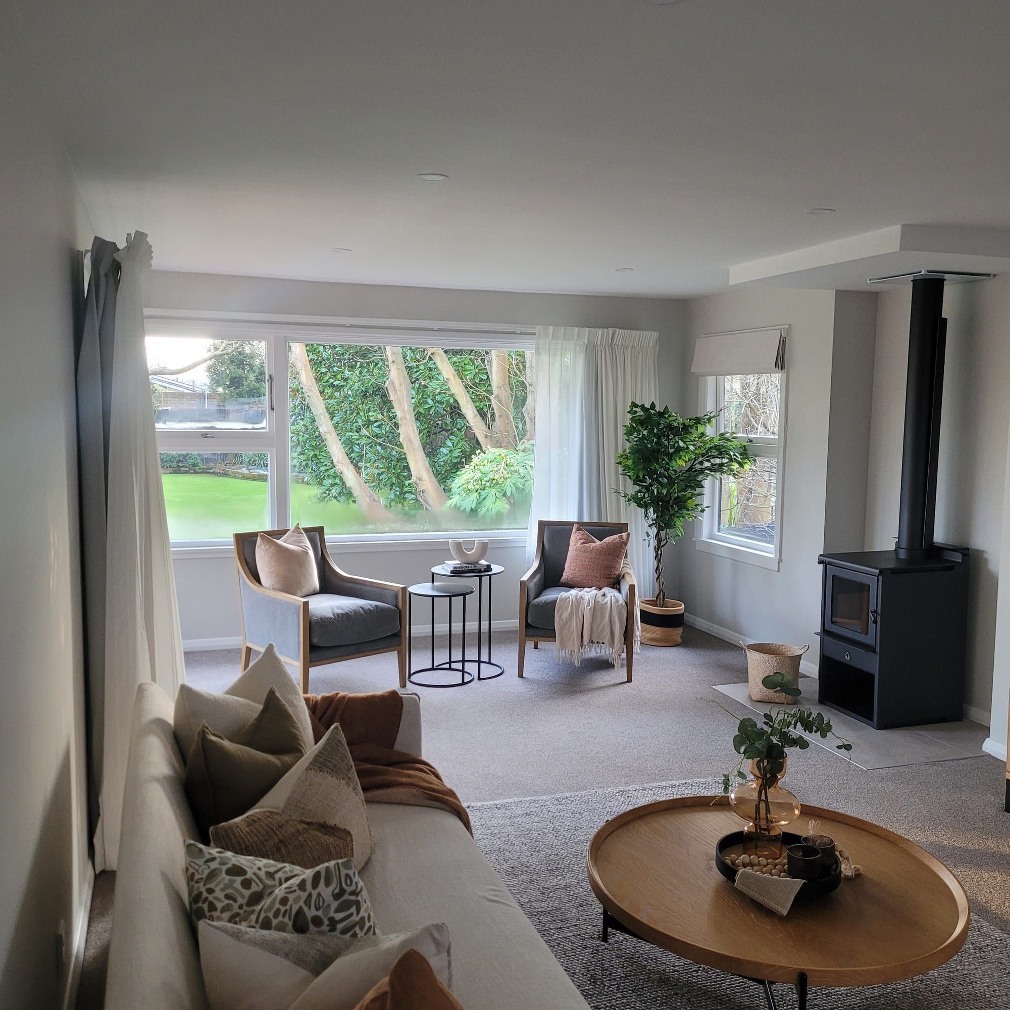 Repainted lounge styled for sale, with a fireplace and garden outlook