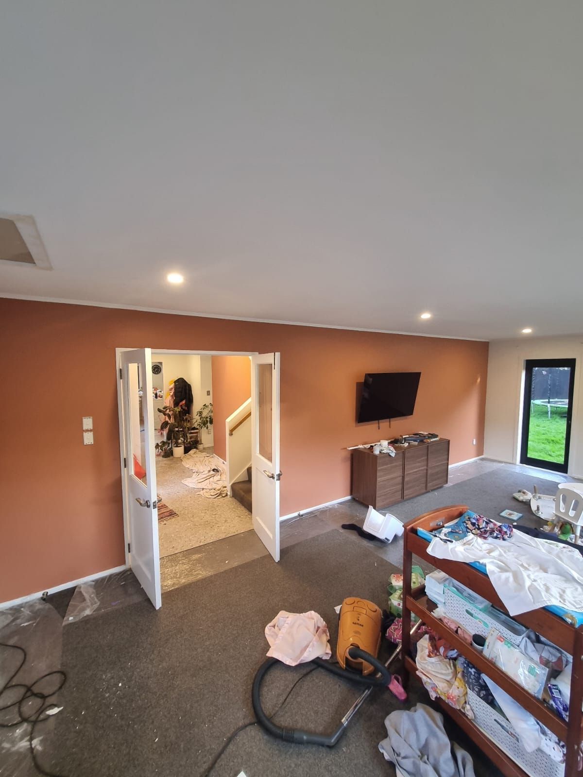 Lounge repaint with a warm terracotta feature wall